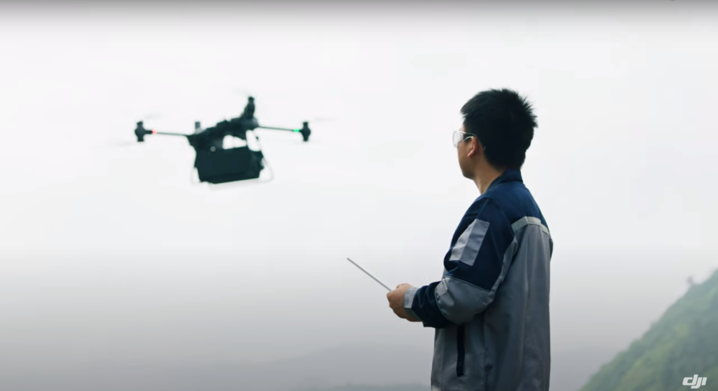 a drone operator flying DJI's new Flycart 30 delivery drone.